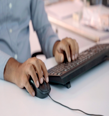 Guy typing on Keyboards